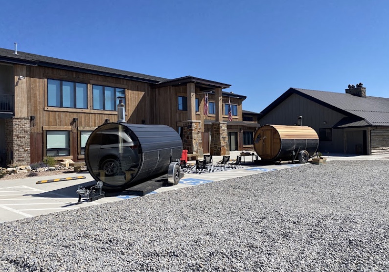 Outdoor barrel saunas and cold plunges at Royal Creek Ranches, offering wellness amenities for overnight retreats guests to relax and recharge.