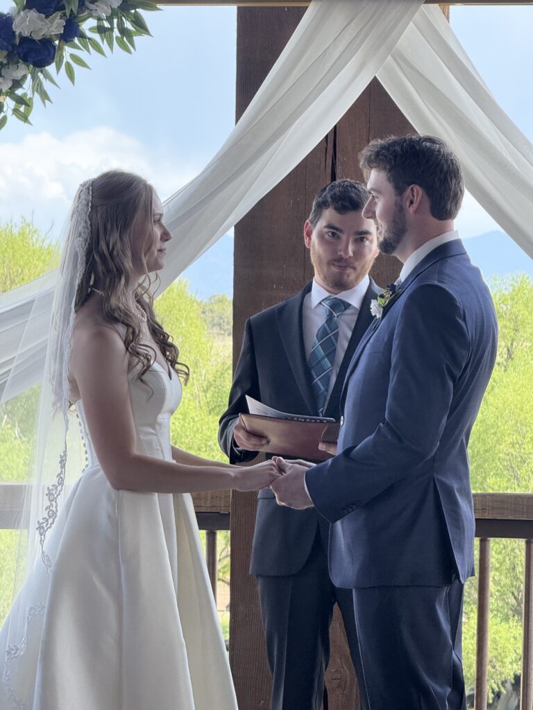 Close-up of bride and groom during wedding ceremony on the Elk Ridge Lodge balcony at Royal Creek Ranches.