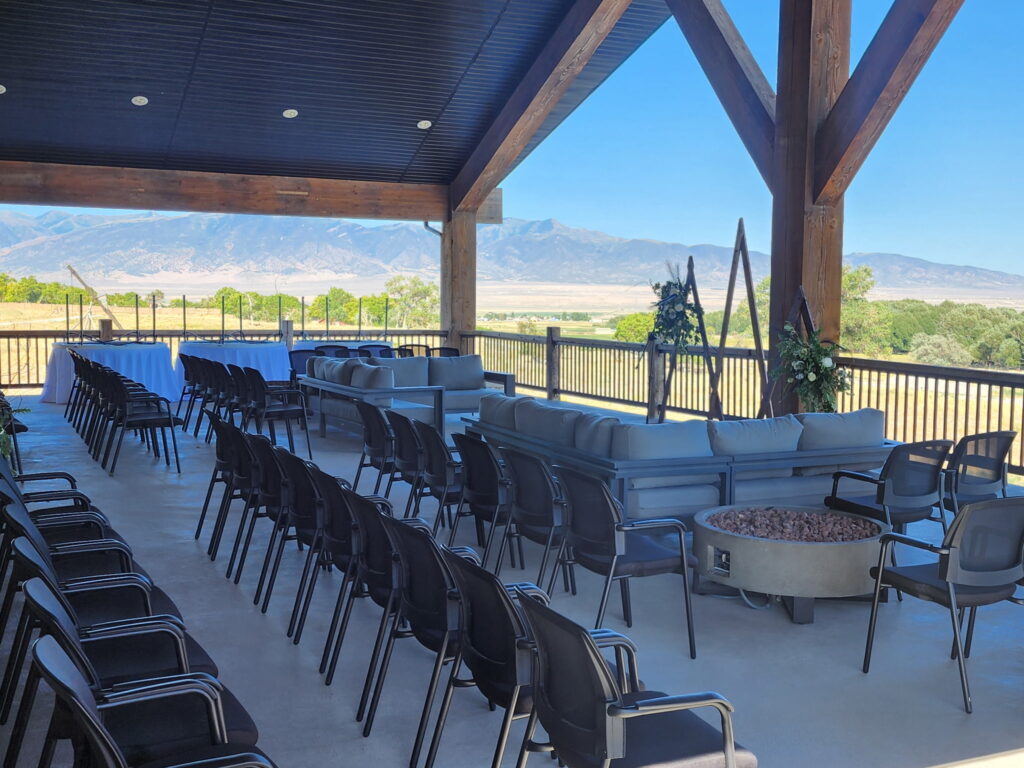 Outdoor wedding setup on Elk Ridge Lodge balcony at Royal Creek Ranches in Utah with chairs and couches.